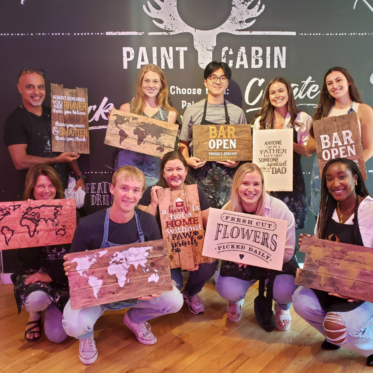 Group Showcasing their completed creations during a Team building activity with Paint Cabin