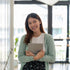 Happy Female holding a binder Testimonial Photo