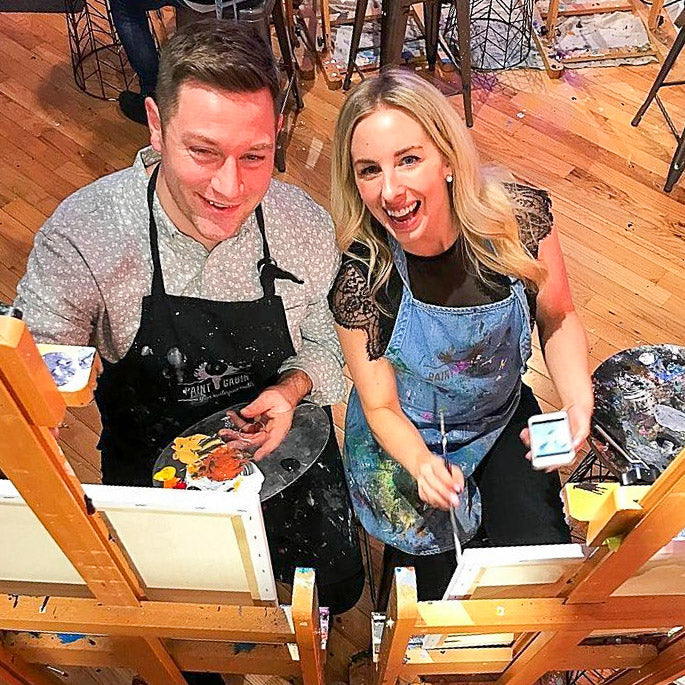 Couple Smiling During their Paint Night with Paint Cabin