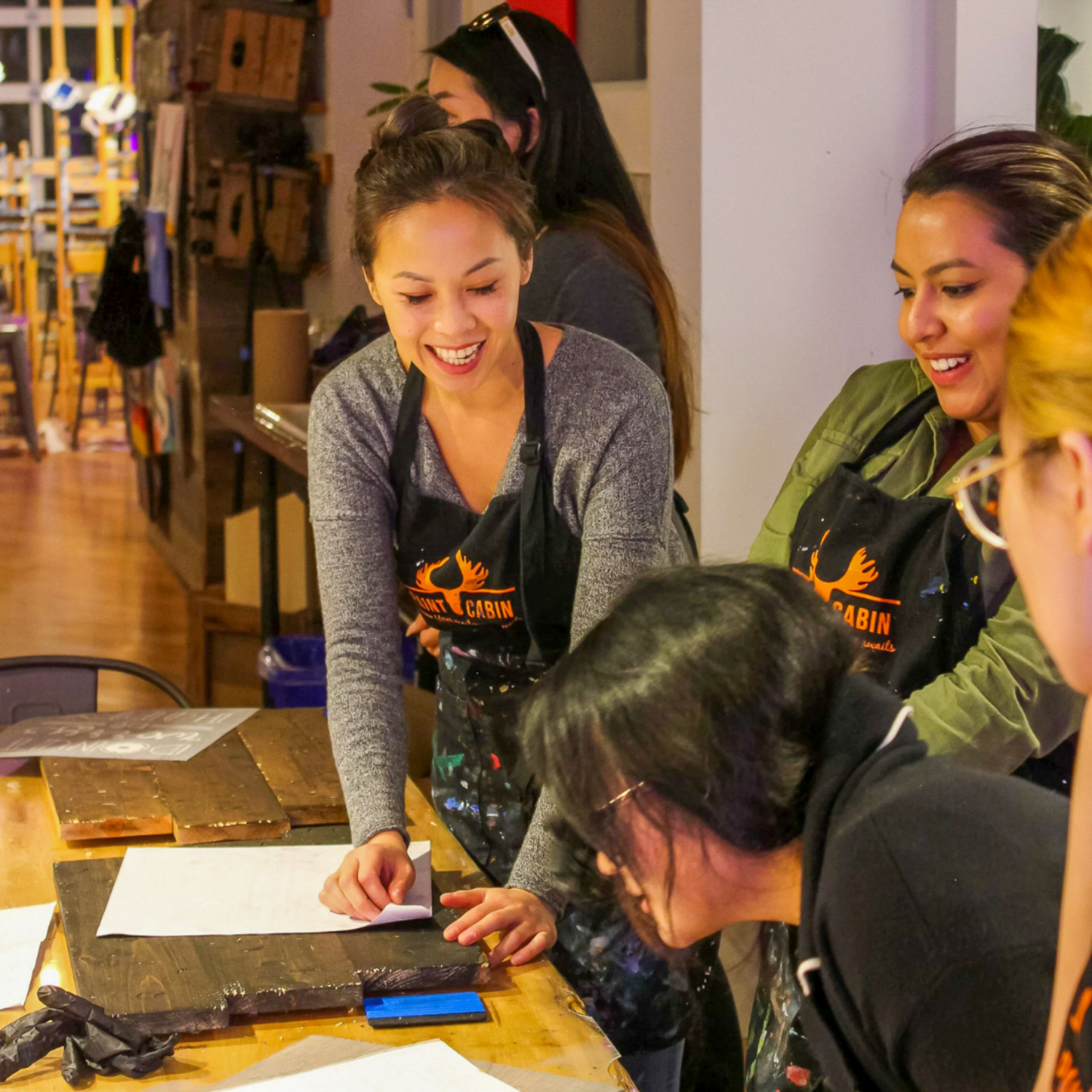 Group working on their DIY Vintage Wood Signs during Paint Cabin Activity